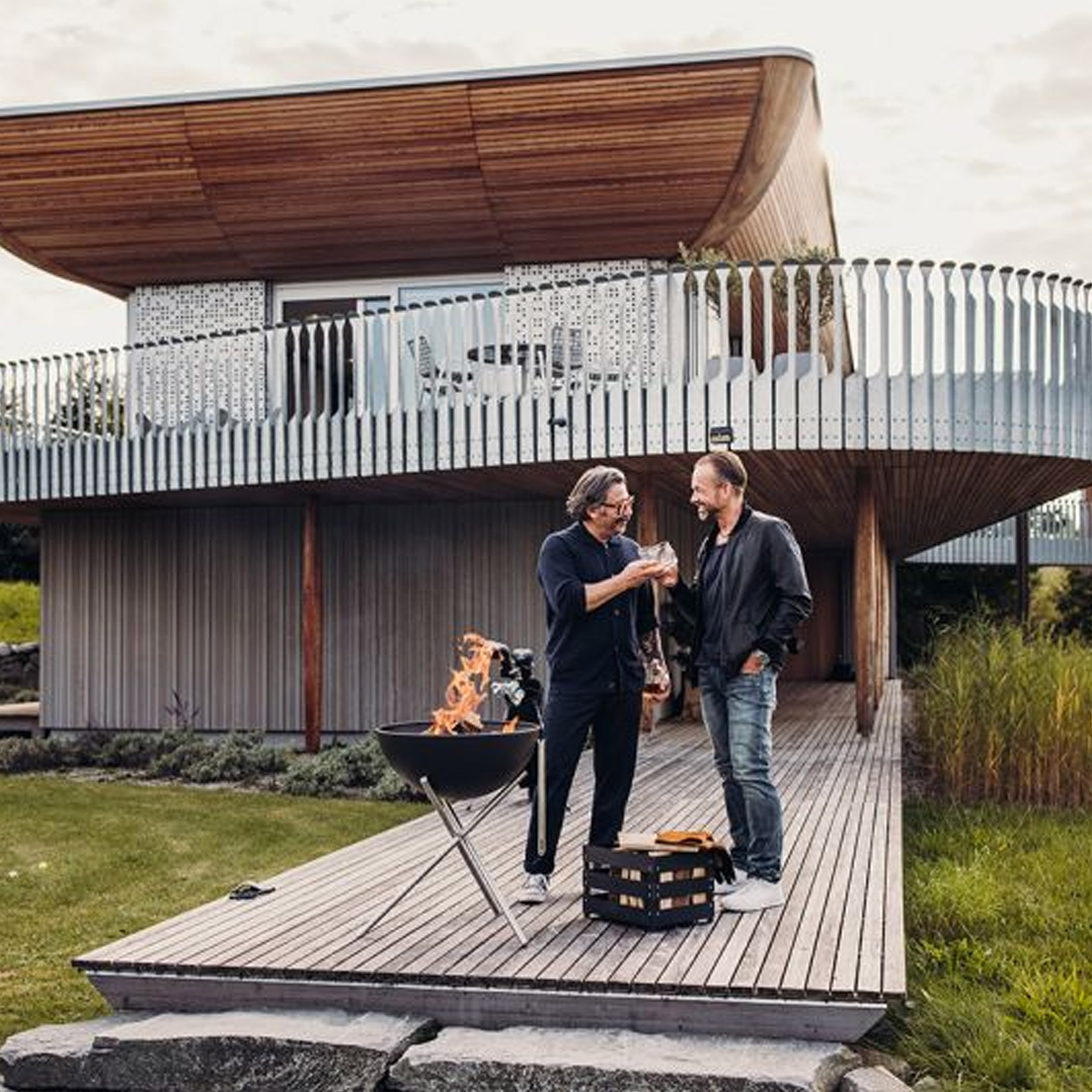 Fire Bowl 57 with tripod, outdoor patio, modern house, deck, fire pit, two men